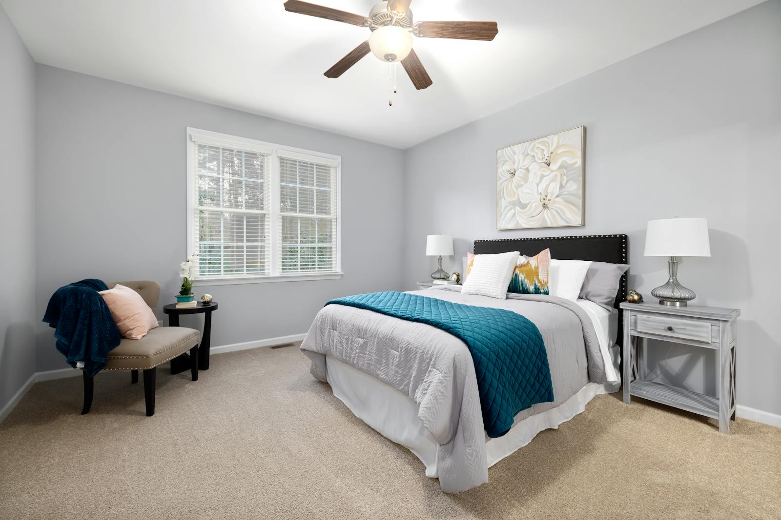 Cozy bedroom with soft carpeted flooring and natural decor